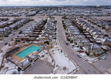 Austin Suburb Homes With Snow Covered Rooftops After Winter Storm Drops Ice And Snow Over Central Texas. Aerial Drone View Above Neighborhood Frozen After Winter Storm Landon