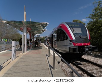 Austin, Texas – 9 October 2022 Passengers Boarding An Austin Light Rail Train Heading North To The Austin FC Football Stadium