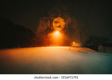 Austin, Texas - Feb 15, 2021: Nightview Of The Blizzard In Austin, Texas. The Snow Is Blowing Strongly. The Road Is Covered By Snow.