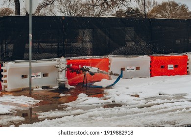 Austin, Texas - Feb 16, 2021: The Day After The Blizzard In Austin, The Water Pipe Bursts On The Road Side.