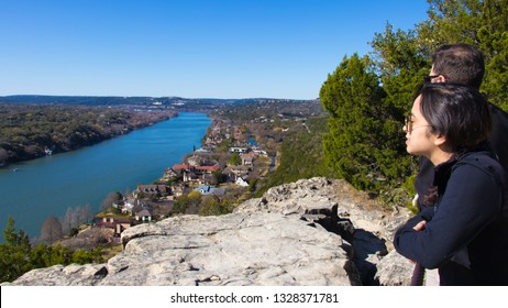 Austin, Texas - Feburary 24 2019: A Man And Woman Overlooking The River And Houses Below Mount Bonnell In Austin