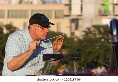 AUSTIN, TEXAS - JUNE 1 2014: A Conductor At An Outdoor Concert Is Very Focused On The Music