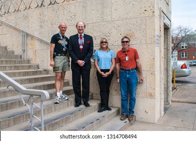 Austin, Texas - March 11 2004: Four Marathon Finishers Standing On Separate Steps Two Of Them Wearing Their Medals