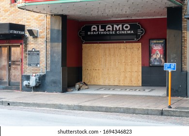 Austin, Texas March 19 2020: A Homeless Person Sleeps In Front Of The Boarded Up Alamo Drafthouse Ritz Theater, Closed Due To The COVID-19 Outbreak, Filed For Chapter 11 Bankrupcty Due To Shutdowns