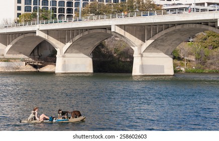 AUSTIN, TEXAS - MARCH 6 2009: A woman and her dogs enjoying a Lady Bird Lake in the center of Austin, Texas.