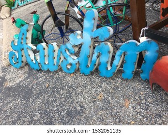 Austin Texas Metal Sign Blue Word On Concrete Floor