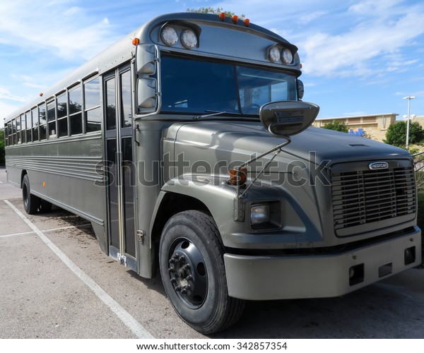 AUSTIN, TEXAS: NOVEMBER 12 2015: Blue Bird school\
bus painted black in three quarter view.  This bus started its life\
painted yellow.