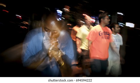 AUSTIN (TEXAS) - SEPTEMBER 2012: Long Exposure Image Of Harmonica Player Performing On Sixth Street, The Night Life Area Of Austin Texas.