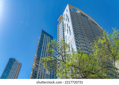 Austin Texas Skyline With Apartments Rising Against Blue Sky On A Sunny Day. Exterior View Of Residential Buildings Featuring Modern Architecture With Balconies And Glass Facade.