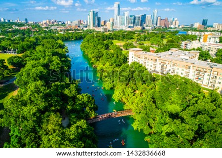 Austin Texas skyline cityscape aerial drone view above green landscape Barton creek flowing into town lake