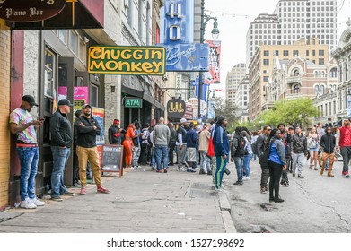 AUSTIN, TEXAS, USA - March 16, 2019: People crowd Sixth Street in Austin Texas during SXSW festival in March 2019. This historic street is famous for its live music bars.