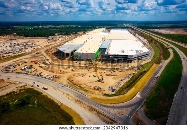 Austin , Texas , USA - September 10th 2021:\
Tesla GigaFactory Austin Texas aerial drone view from above the\
Largest construction project in America building Future Electric\
Cybertruck and Batteries