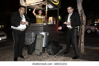 AUSTIN, TEXAS/USA - OCTOBER 2012: Mariachi Duo Having A Snack At A Food Stand On Six Street, The Night Life Hub In Austin.