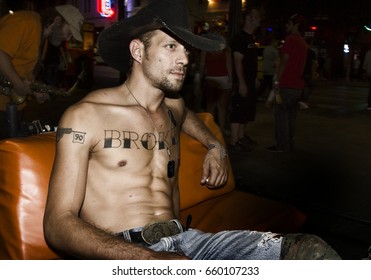 AUSTIN, TEXAS/USA - SEPTEMBER 2012: Pedicab Driver With Cowboy Hat Relaxing While Waiting For Clients On Six Street, The Night Life Hub In Austin, Texas