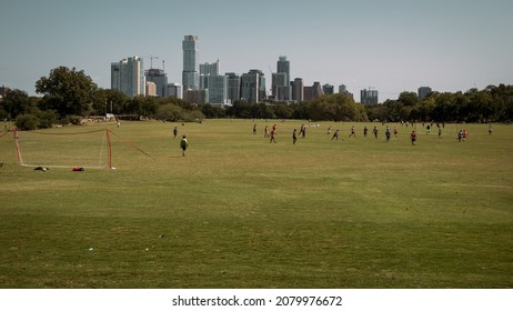 Austin, TX, USA 11-11-2021 Teens Playing Soccer With Austin Skyline On The Background