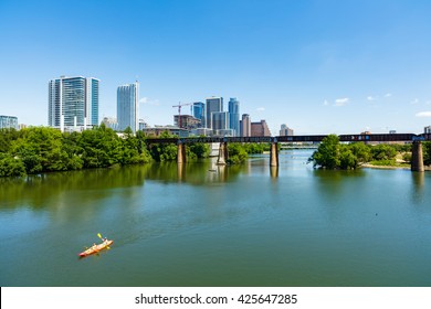 Austin, TX USA - April 14: Skyline View Of The Downtown Area Along The Colorado River With Kayakers Cruising By.