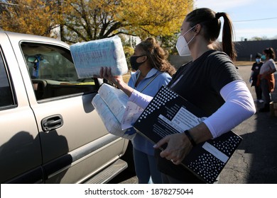 Austin, TX USA - Dec. 12, 2020:  Two Weeks Before Christmas, Two Female Volunteers For The Austin Diaper Bank Give Boxes Of Free Diapers To A Family In Need At A Drive Thru Event.