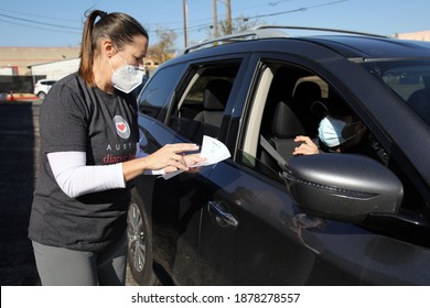 Austin, TX USA - Dec. 12, 2020:  Two Weeks Before Christmas, A Female Volunteer For The Austin Diaper Bank Confirms The Number Of Free Diapers To Give To A Family In Need At A Drive Thru Event.