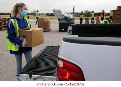 Austin, TX USA - Feb. 4, 2021: A Young Female Volunteer Distributes Emergency Food Aid From The Central Texas Food Bank To People In Need At The Expo Center.