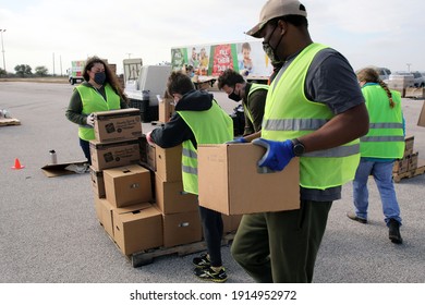 Austin, TX USA - Feb. 4, 2021:  Volunteers organize emergency food aid being distributed by the Central Texas Food Bank to people in need at a drive through event at the Exposition Center.