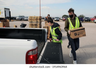 Austin, TX USA - Feb. 4, 2021: A Female And A Male Volunteer Distribute Emergency Food Aid From The Central Texas Food Bank To People In Need At A Drive Through Event At The Exposition Center.