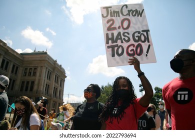 Austin, TX, USA - July 31, 2021: A young Black woman demonstrator at a rally at the Capitol protests voting rights limitations contained in bills written by Republicans in the state legislature .