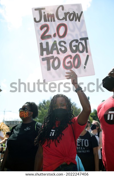 Austin, TX, USA - July 31, 2021: A young Black woman \
demonstrator at a rally at the Capitol protests voting rights\
limitations contained in bills written by Republicans in the state\
legislature .