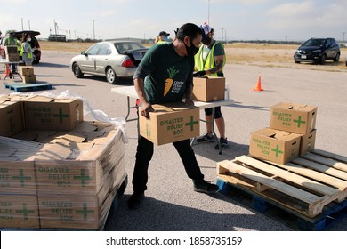 Austin, TX / USA - Nov. 19, 2020: One Week Before Thanksgiving, An Employee Of The Central Texas Food Bank Transfers Disaster Relief  Boxes For Distribution To People In Need.