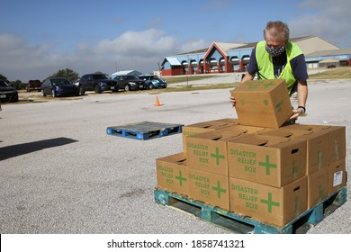 Austin, TX / USA - Nov. 19, 2020: One Week Before Thanksgiving, A Male Volunteer For The Central Texas Food Bank Transfers Disaster Relief Boxes For Distribution To People In Need.