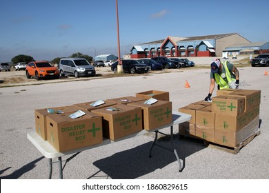 Austin, TX USA - Nov. 19, 2020: One Week Before Thanksgiving, A Male Volunteer For The Central Texas Food Bank Transfers Disaster Relief Boxes For Distribution To People In Need At The Expo Center.