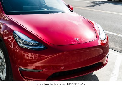 Austin,Texas / USA - June 6th 2020: The Red Hot Electric Car Startup Company Tesla , The Top Seller Electric SUV In A Red Finish Parked On The Sidewalk