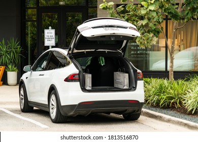 Austin,Texas / USA - September 12th 2020: The Hot Electric Car startup company Tesla Model X with its Trunk opened with luxury purchases and bags in the back of the Vehicle