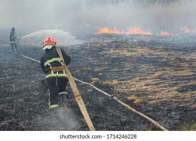 Australia Bushfires, The Fire Is Fueled By Wind And Heat. Firefighters Spray Water To Wildfire