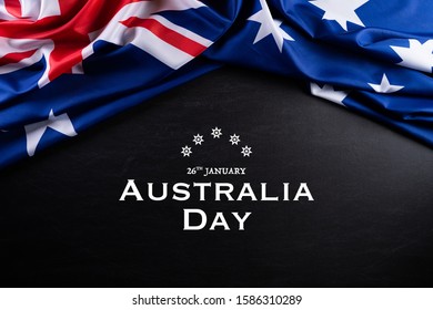 Australia day concept. Australian flag with the text Happy Australia day against a blackboard background. 26 January. - Powered by Shutterstock