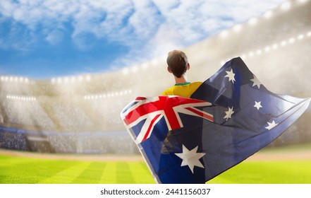 Australia fans on stadium. Australian supporters. Crowd cheering for Aussie football or cricket team victory. Soccer match on outdoor pitch. Patriotic party with national flag and jersey. - Powered by Shutterstock