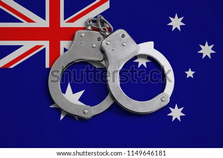 Australia flag  and police handcuffs. The concept of observance of the law in the country and protection from crime
