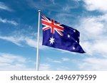 Australia flag waving at cloudy sky background. the Commonwealth of Australia flag