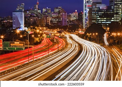 Australia NSW Sydney City Cahill Expressway At Sunset With Long Blurred Traffic Lights Multi-lane Motor Road Towards CBD, Harbour Bridge And Illuminated Landmarks