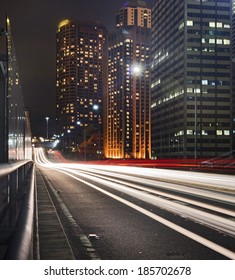 Australia Sydney Big City CBD At Sunset Express Motor Way Lane With Long Exposure Of Car Headlights And Skyscrapers In Background