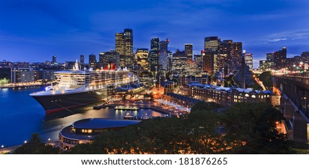 australia Sydney CBD panoramic view from harbour bridge to Circular quay passenger terminal with docked liner illuminated skyscrapers and the city