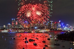 Australia Sydney City CBD Close View At New Year Firewalls With Red Balls Hanging Over Skyscrapers And Reflecting In Harbour Water