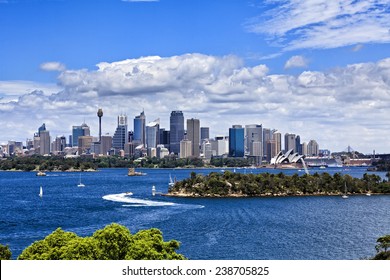 Australia Sydney city CBD view from Taronga zoo over harbour waters sunny bright summer day lush colours and white clouds in blue sky
