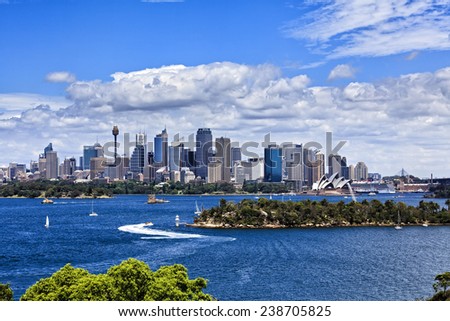Australia Sydney city CBD view from Taronga zoo over harbour waters sunny bright summer day lush colours and white clouds in blue sky