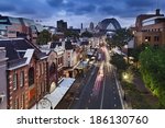 australia sydney the rocks historic district in the city view from top on george street illuminated houses and Sydney Bridge in the background at sunset