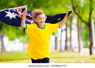 Australia team fans with flag. Australian supporter child. Kid cheering for Aussie football or cricket team victory. Happy little boy with national flag. Patriotic party. - Powered by Shutterstock