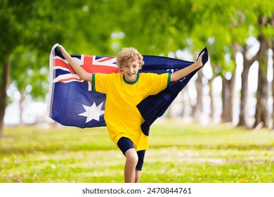 Australia team fans with flag. Australian supporter child. Kid cheering for Aussie football or cricket team victory. Happy little boy with national flag. Patriotic party. - Powered by Shutterstock