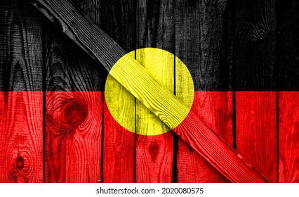 Australian Aboriginal Flag Is Depicted On A Wooden Background Close-up