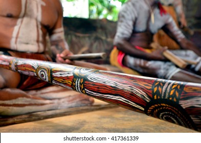 Australian Aboriginal Men Playing  Aboriginal Music On Didgeridoo And Wooden Instrument During Aboriginal Culture Show In Queensland, Australia.