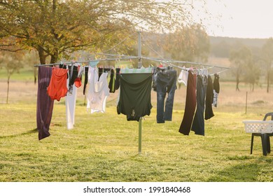 Australian backyard featuring hills hoist clothes line full of clean washing