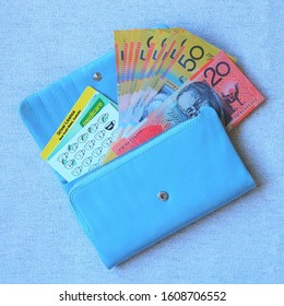 Australian bank notes, driver licence, medicare and coffee stamp cards in blue purse